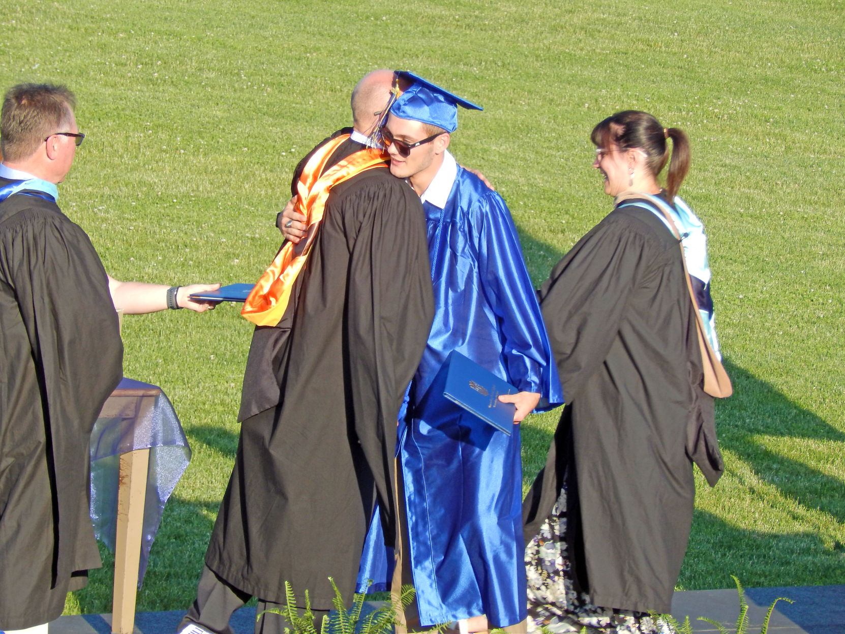 Kevin Lampman hugs Principal Jon Koeng as he receives his diploma June 27.